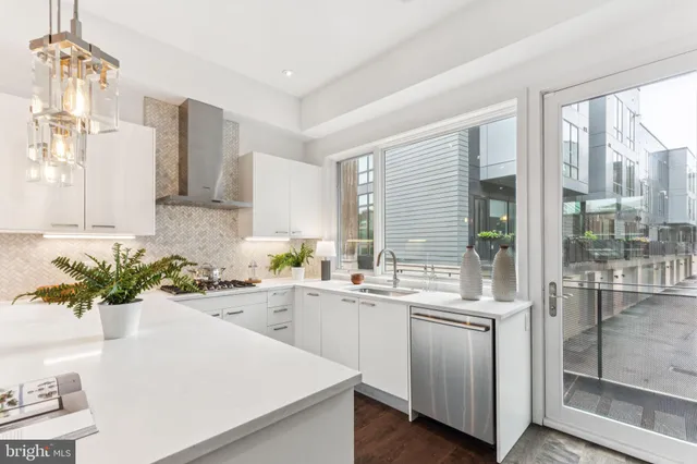 a kitchen with a sink a stove and cabinets