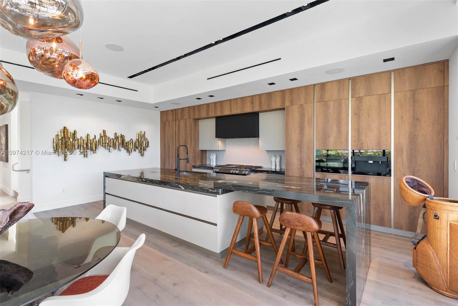 5470 La Gorce Drive Miami Beach, FL 33140 - Photo 15 of 71 a large white kitchen with a large window