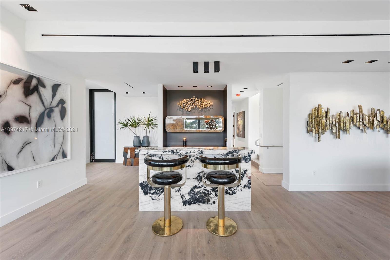 5470 La Gorce Drive Miami Beach, FL 33140 - Photo 21 of 71 a view of a livingroom with furniture and wooden floor