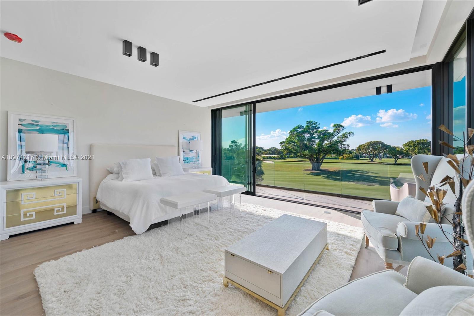 5470 La Gorce Drive Miami Beach, FL 33140 - Photo 25 of 71 a spacious bedroom with a bed and a view of balcony