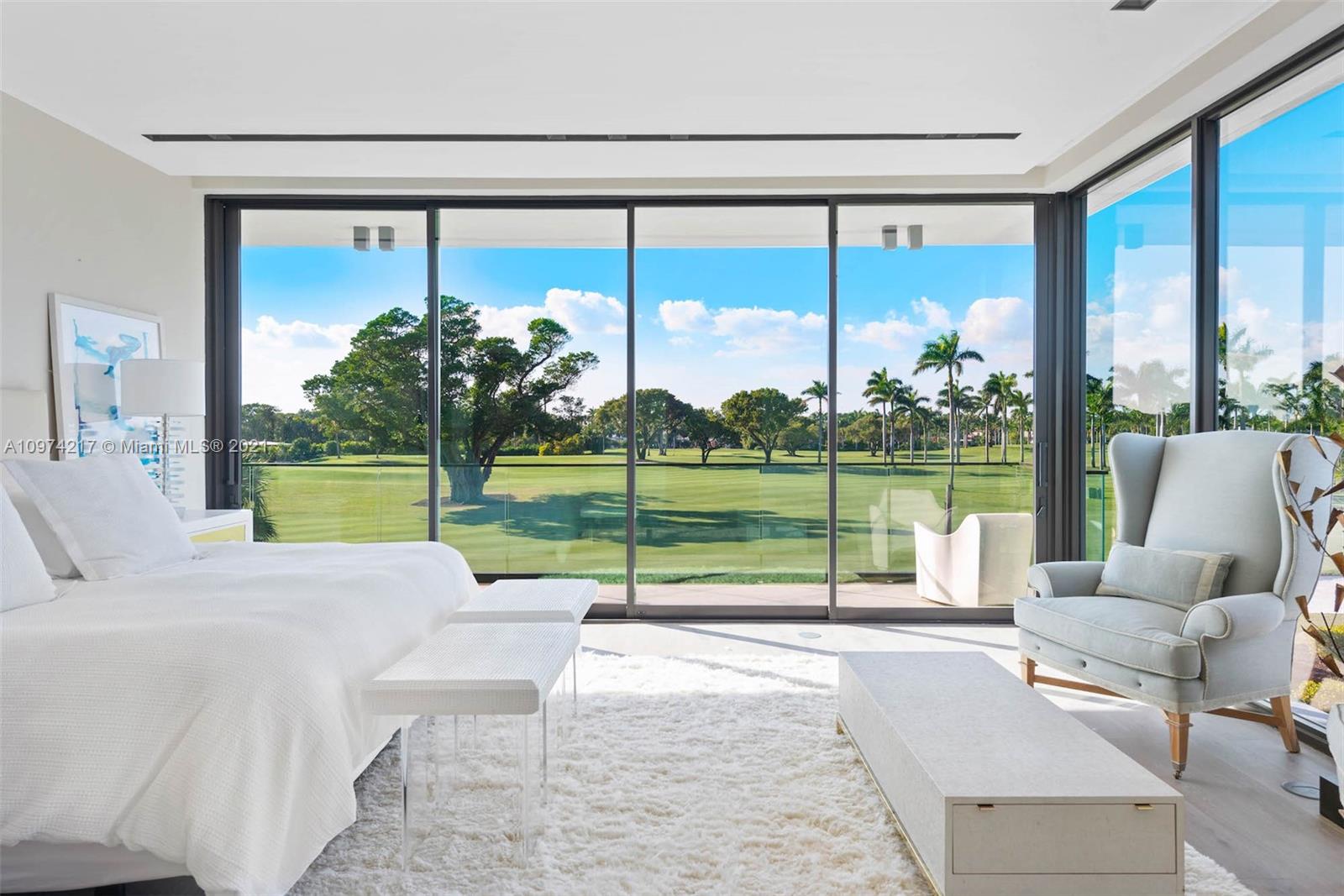 5470 La Gorce Drive Miami Beach, FL 33140 - Photo 28 of 71 a living room with a large window and a table