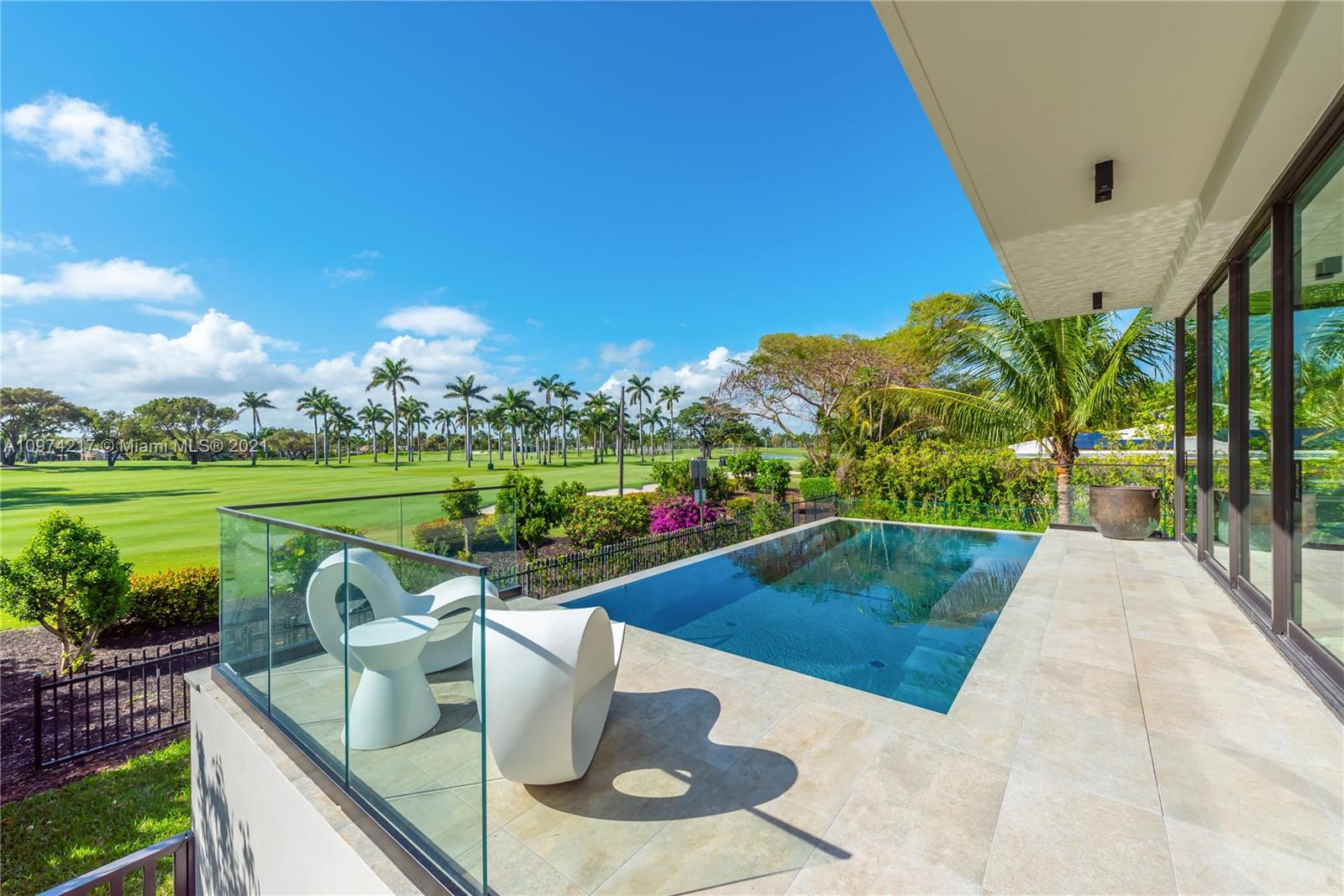 5470 La Gorce Drive Miami Beach, FL 33140 - Photo 3 of 71 a view of a swimming pool with a patio