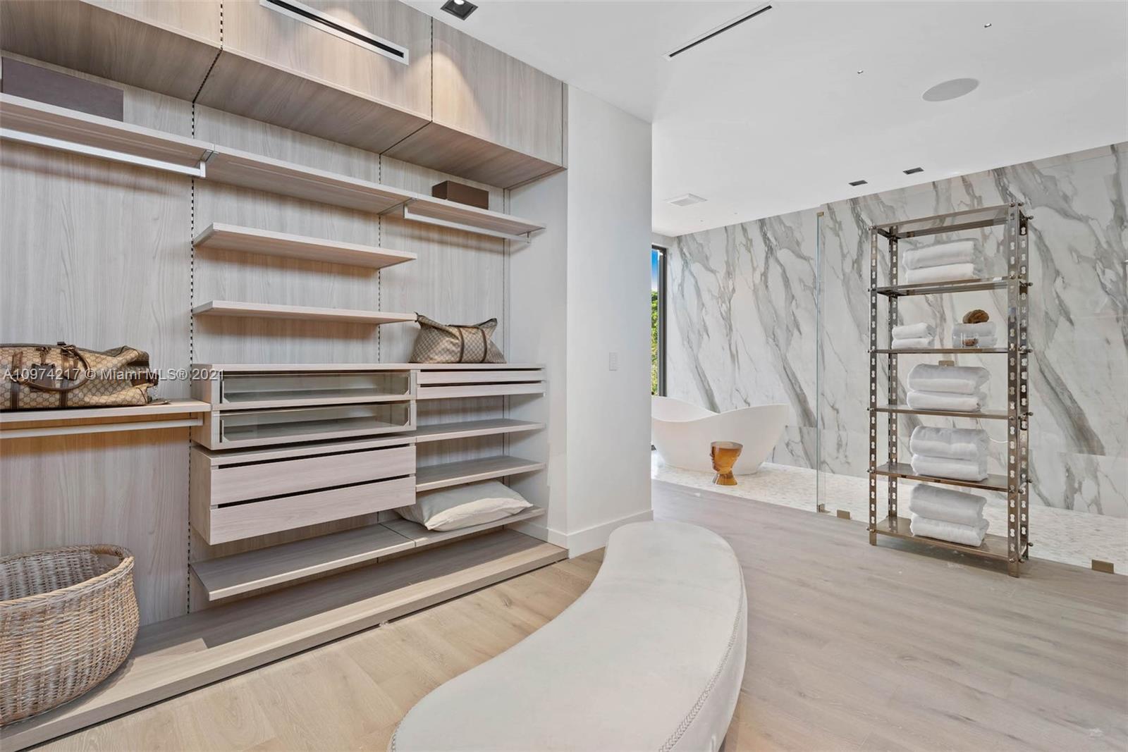 5470 La Gorce Drive Miami Beach, FL 33140 - Photo 41 of 71 a view of walk in closet with clothes and shoes