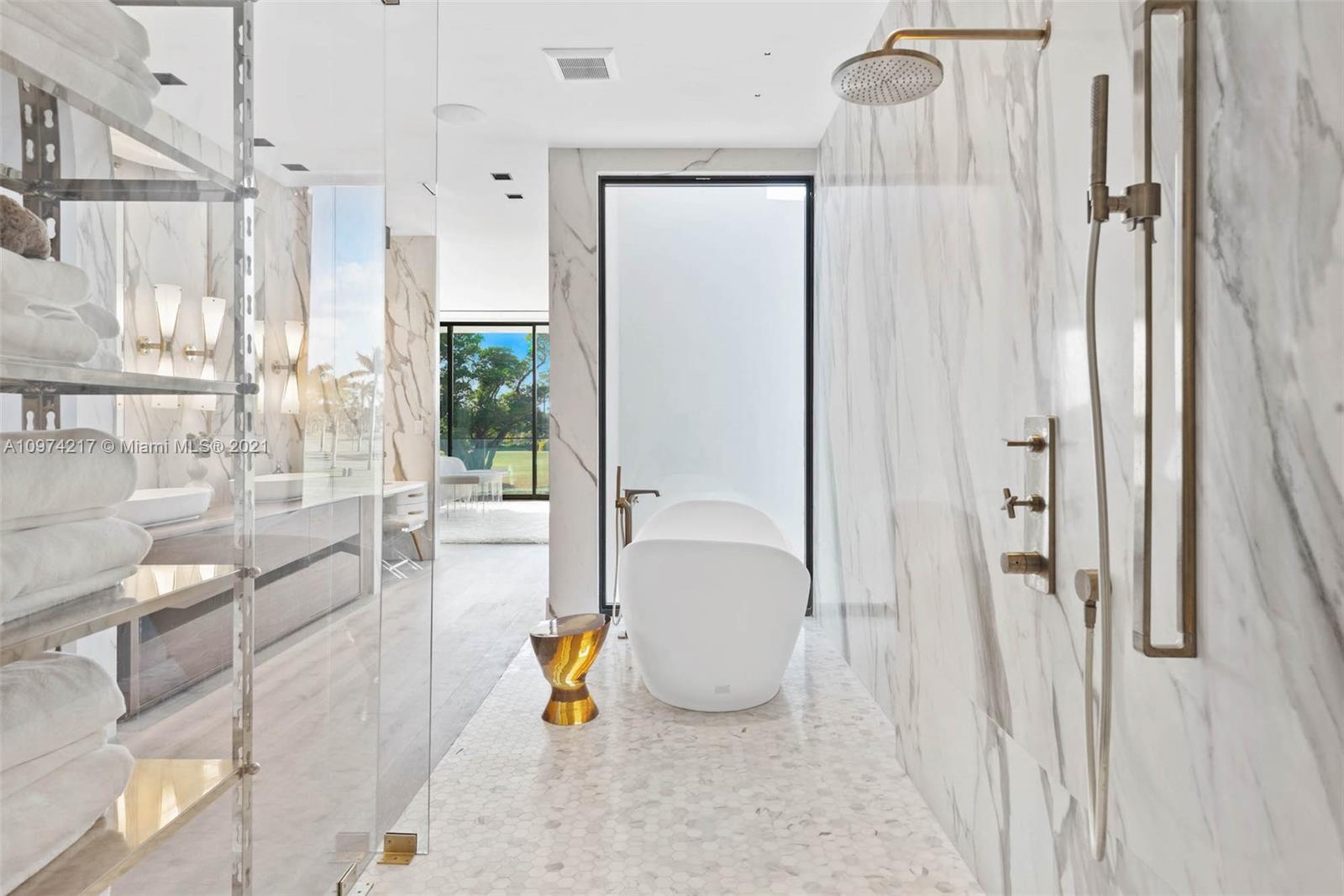 5470 La Gorce Drive Miami Beach, FL 33140 - Photo 45 of 71 a bathroom with a tub and shower