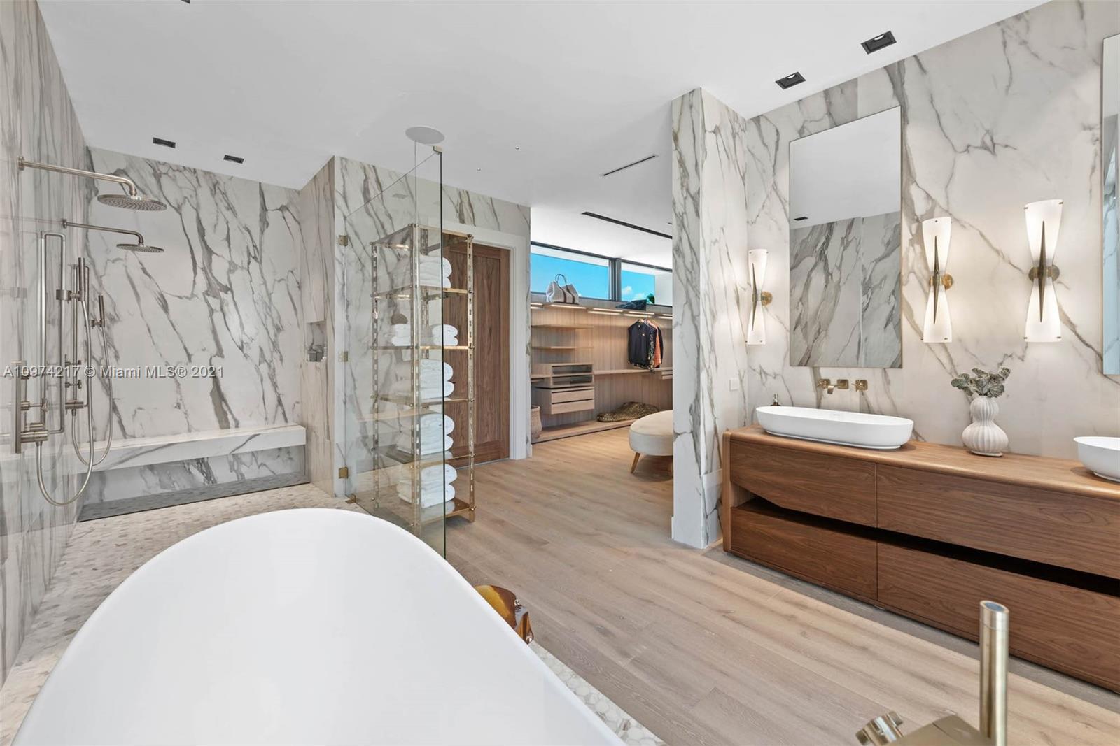 5470 La Gorce Drive Miami Beach, FL 33140 - Photo 46 of 71 a bathroom with a double vanity sink and a mirror