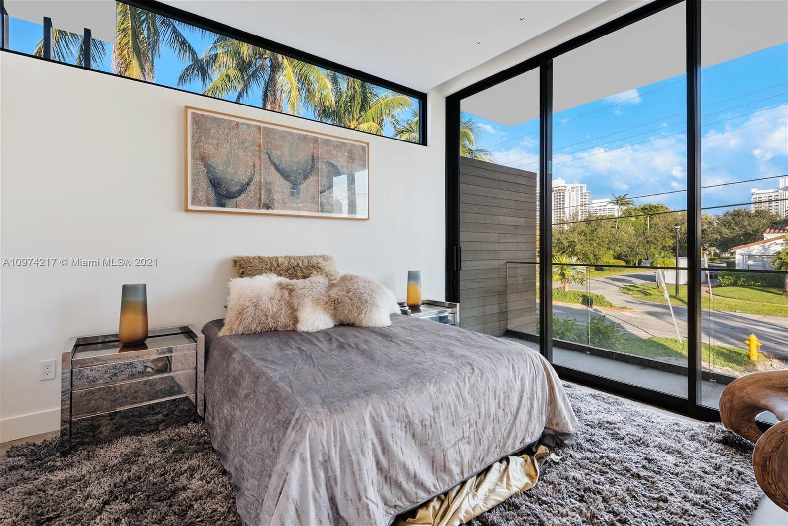 5470 La Gorce Drive Miami Beach, FL 33140 - Photo 57 of 71 a bedroom with a large bed and a painting on the wall