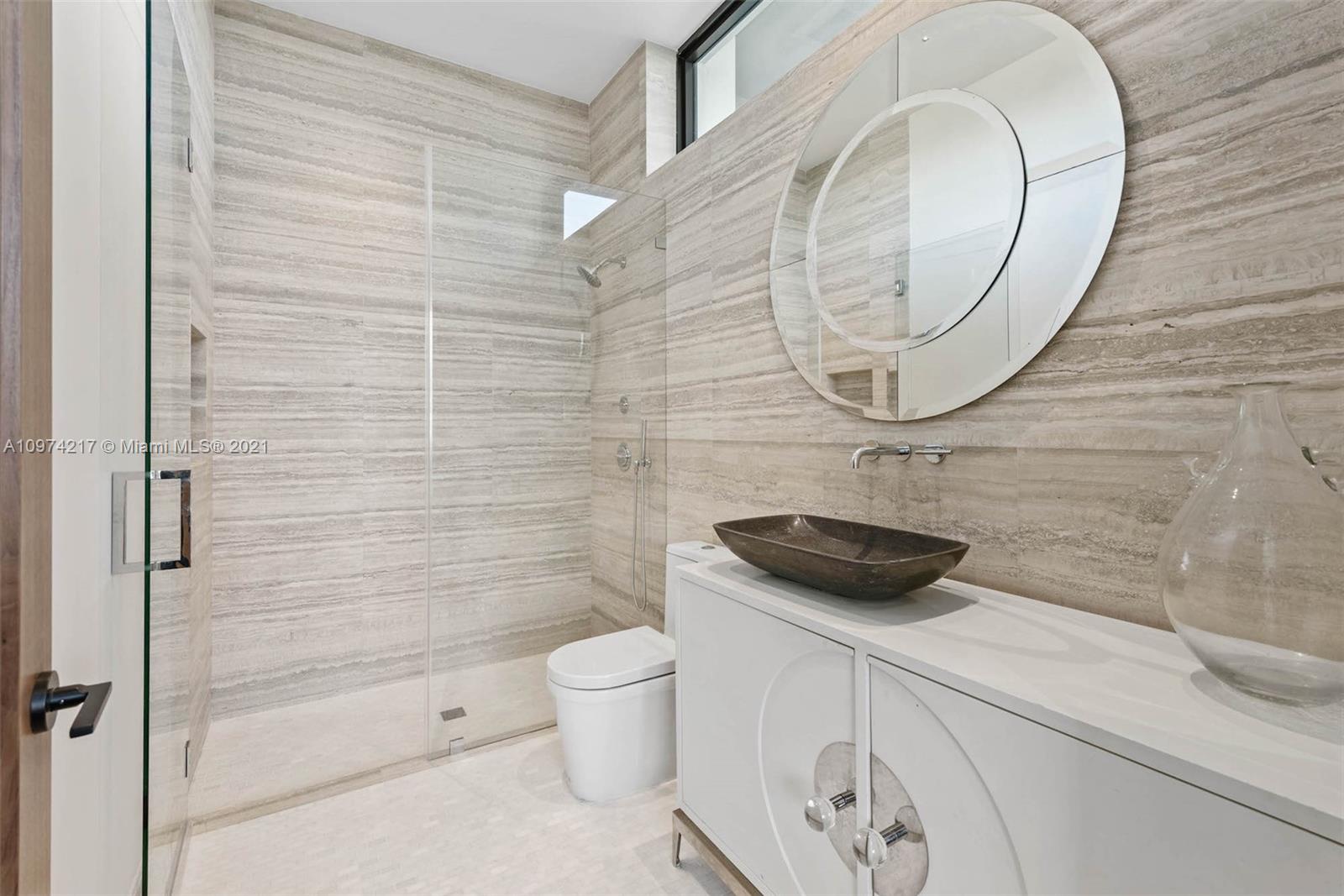 5470 La Gorce Drive Miami Beach, FL 33140 - Photo 60 of 71 a bathroom with a sink a toilet and shower