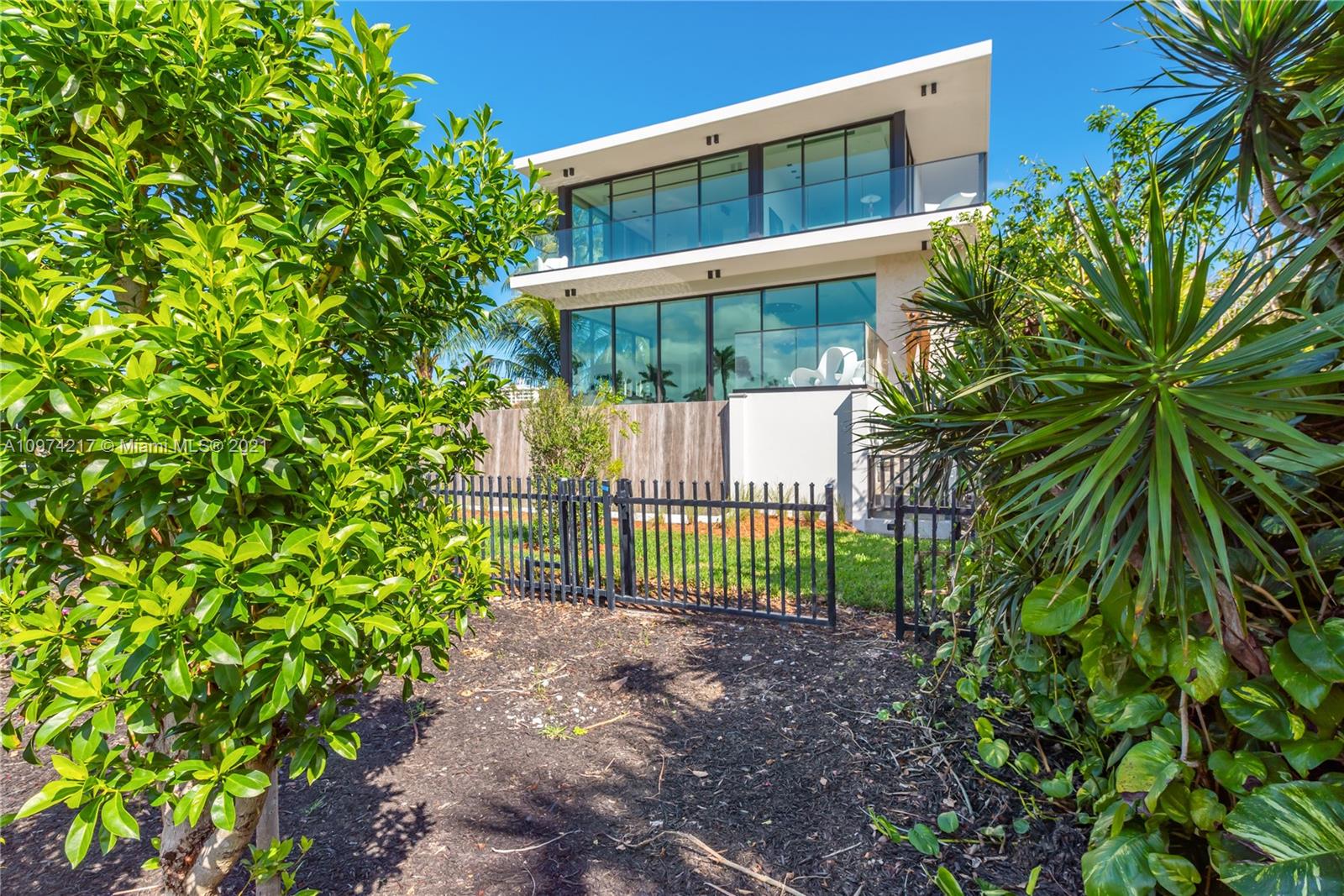 5470 La Gorce Drive Miami Beach, FL 33140 - Photo 61 of 71 a view of a house with a small yard and a large tree
