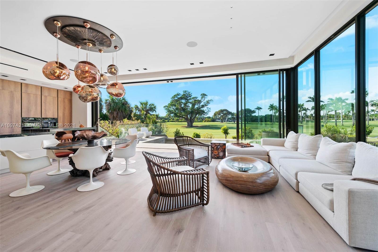 5470 La Gorce Drive Miami Beach, FL 33140 - Photo 8 of 71 a living room with patio furniture and a floor to ceiling window