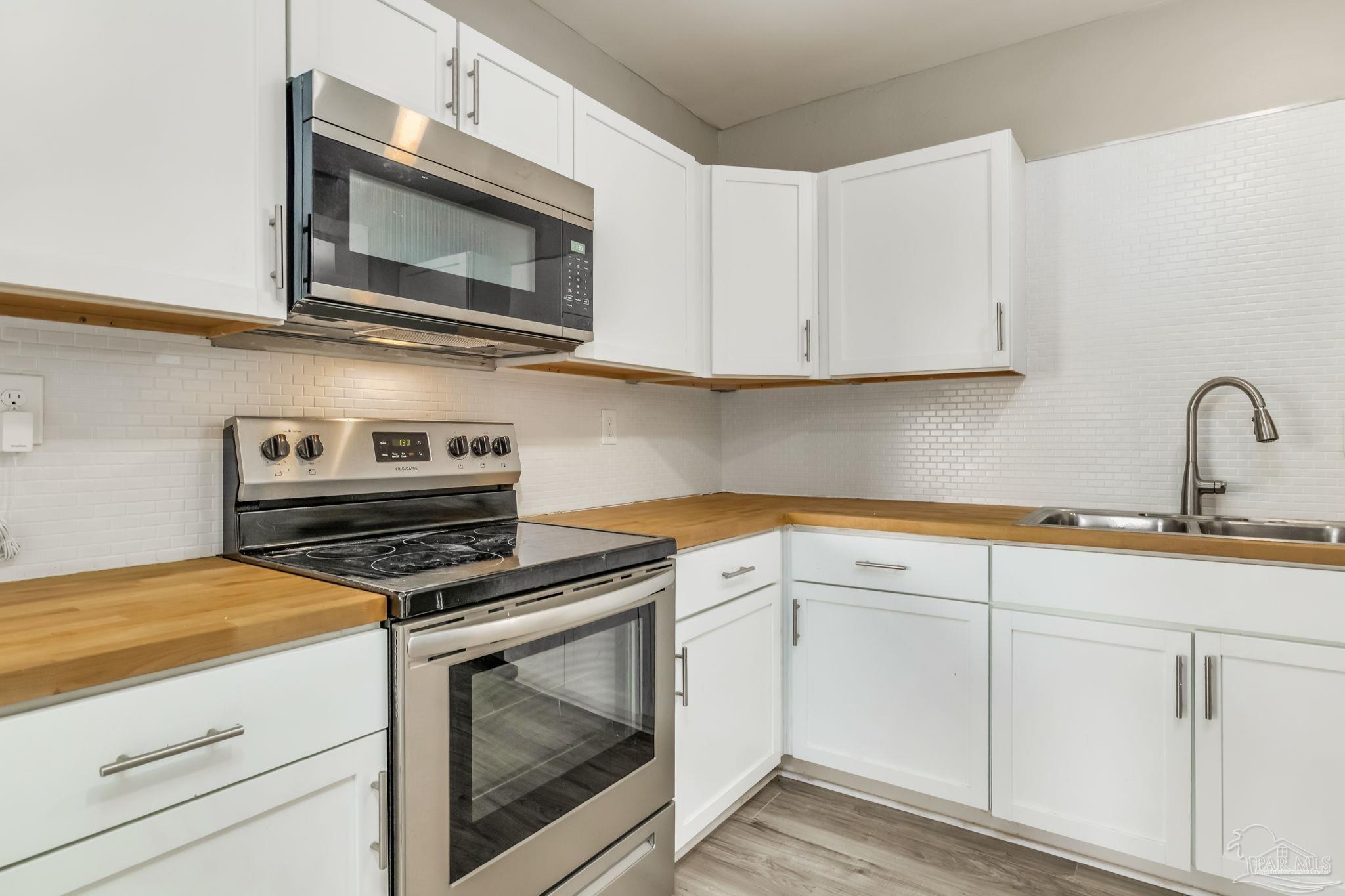 207 Bryant Road Pensacola, FL 32507 - Photo 12 of 23 a kitchen with cabinets stainless steel appliances and a sink