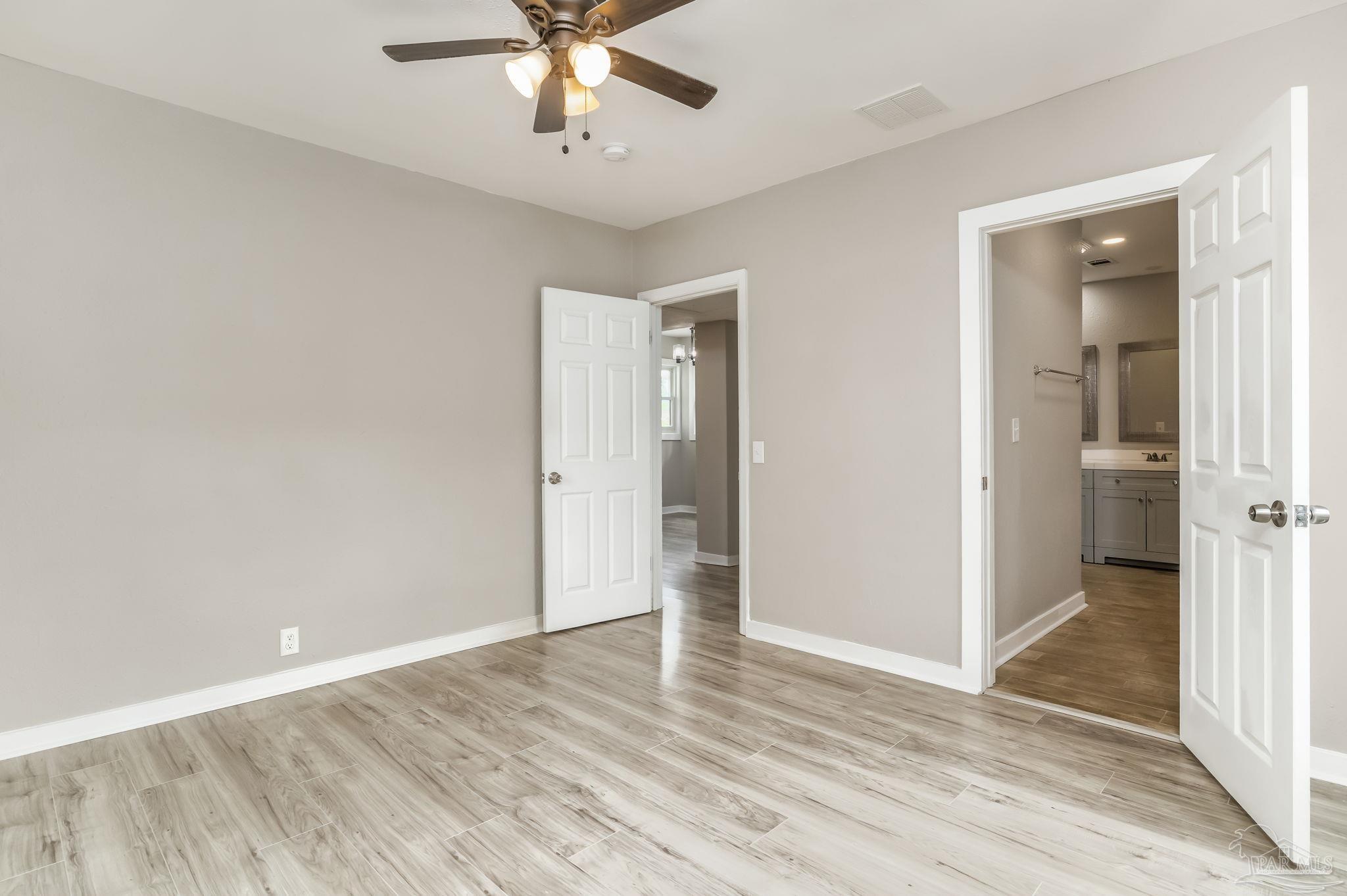 207 Bryant Road Pensacola, FL 32507 - Photo 14 of 23 wooden floor in an empty room with a window