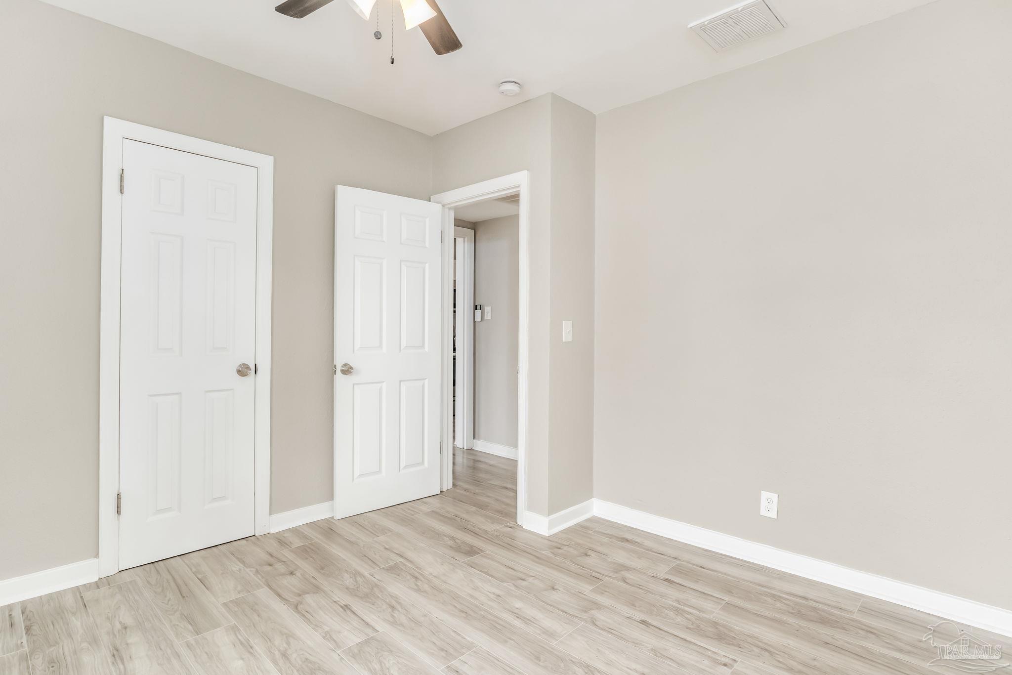 207 Bryant Road Pensacola, FL 32507 - Photo 17 of 23 a view of an empty room with a ceiling fan