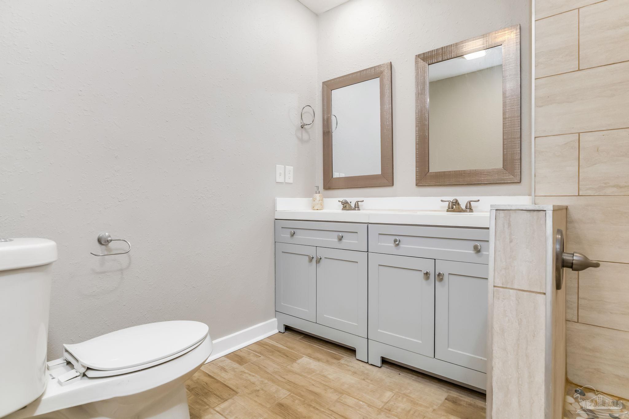 207 Bryant Road Pensacola, FL 32507 - Photo 22 of 23 a bathroom with a toilet sink and mirror
