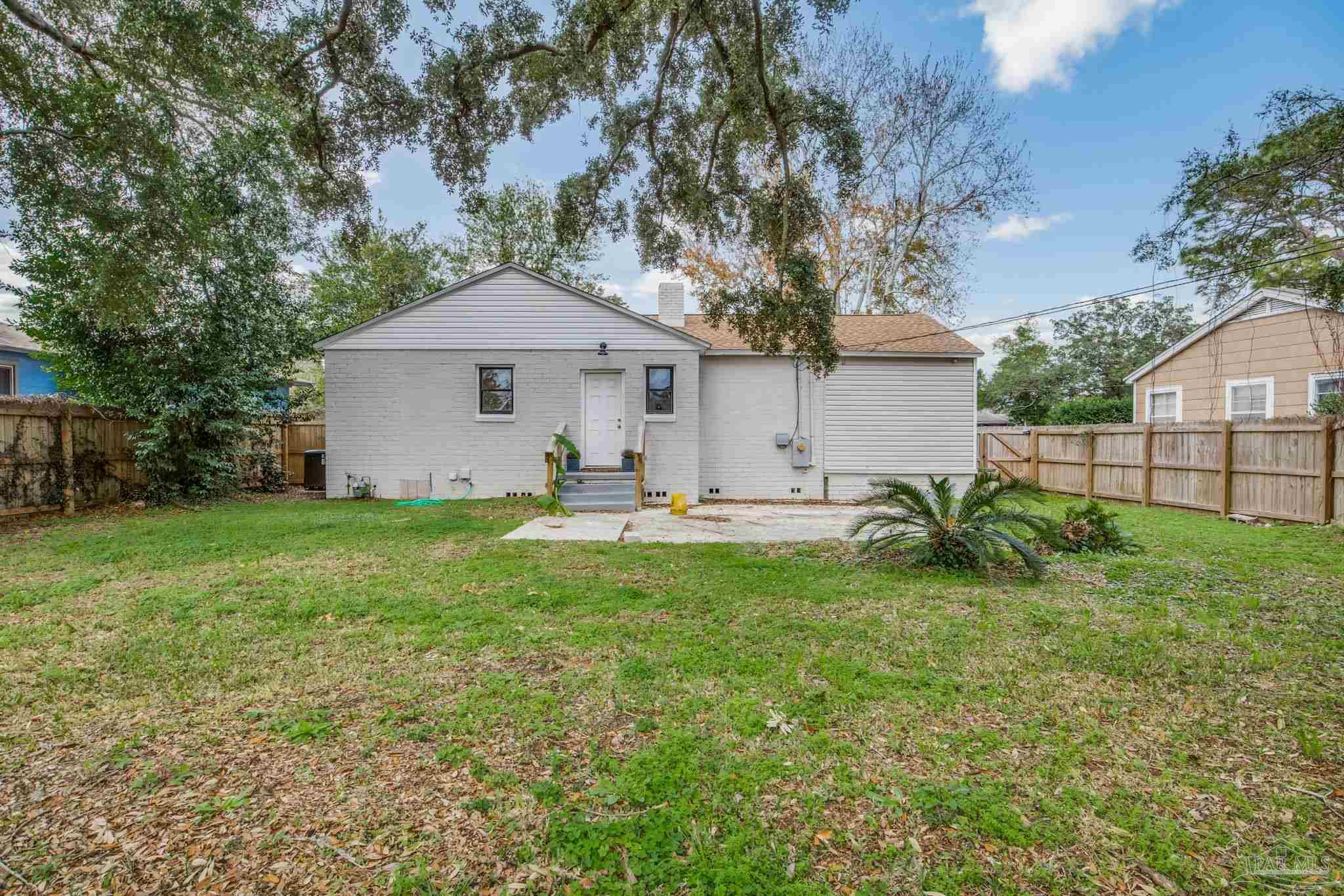207 Bryant Road Pensacola, FL 32507 - Photo 4 of 23 a front view of a house with garden