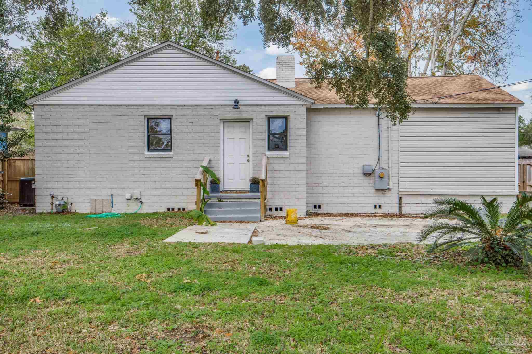 207 Bryant Road Pensacola, FL 32507 - Photo 5 of 23 a view of a house with a yard and tree