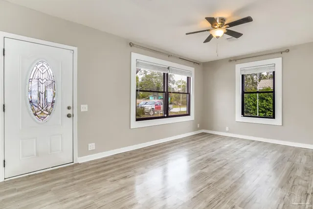a view of livingroom with window ceiling fan and wooden floor