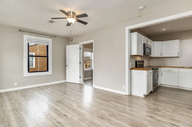 a view of kitchen with sink and wooden floor