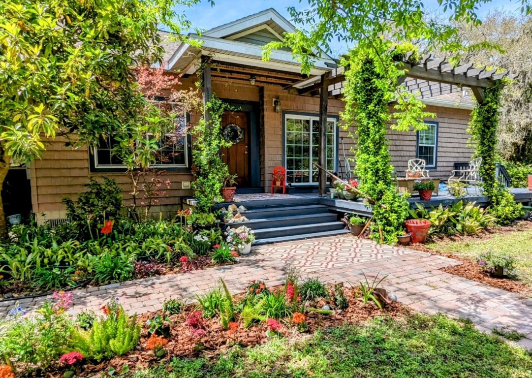795 Geiger Road Amelia Island, FL 32034 - Photo 1 of 17 a view of a house with wooden walls and flower plants