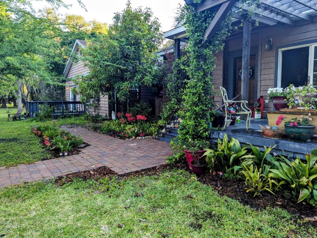795 Geiger Road Amelia Island, FL 32034 - Photo 11 of 17 a view of a house with a yard and garden