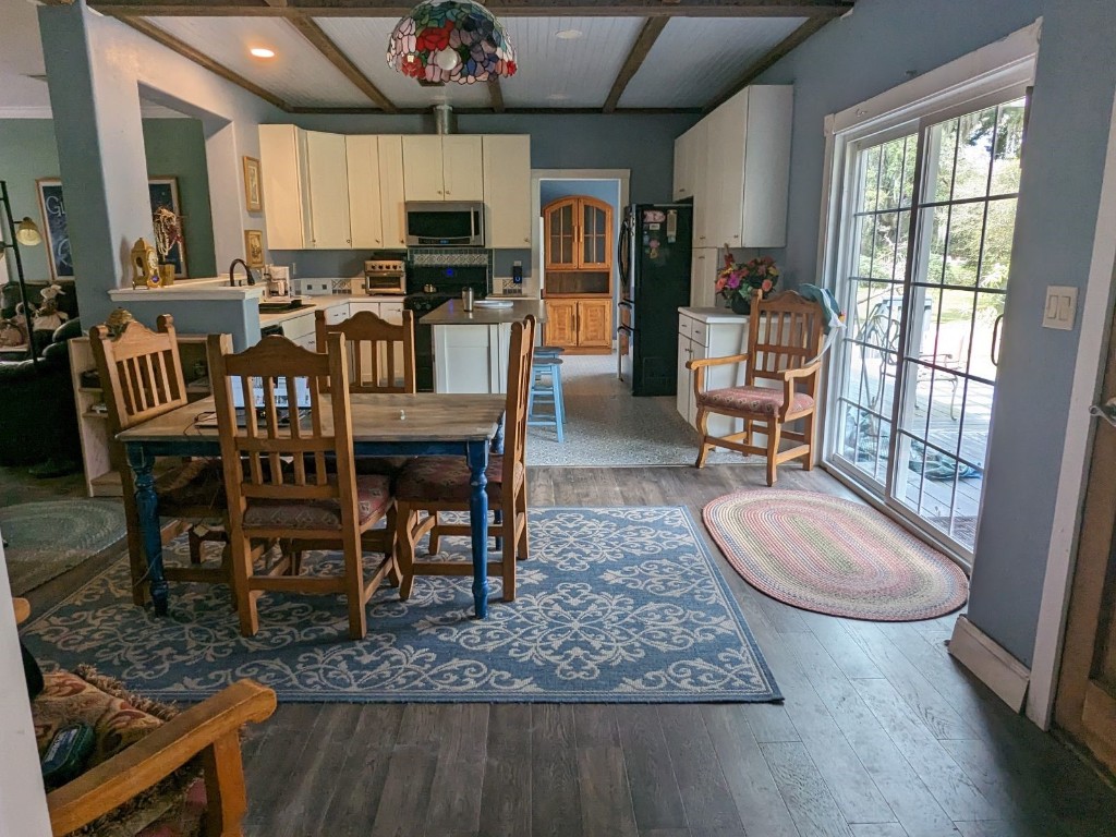 795 Geiger Road Amelia Island, FL 32034 - Photo 4 of 17 a view of a dining room with furniture window and wooden floor