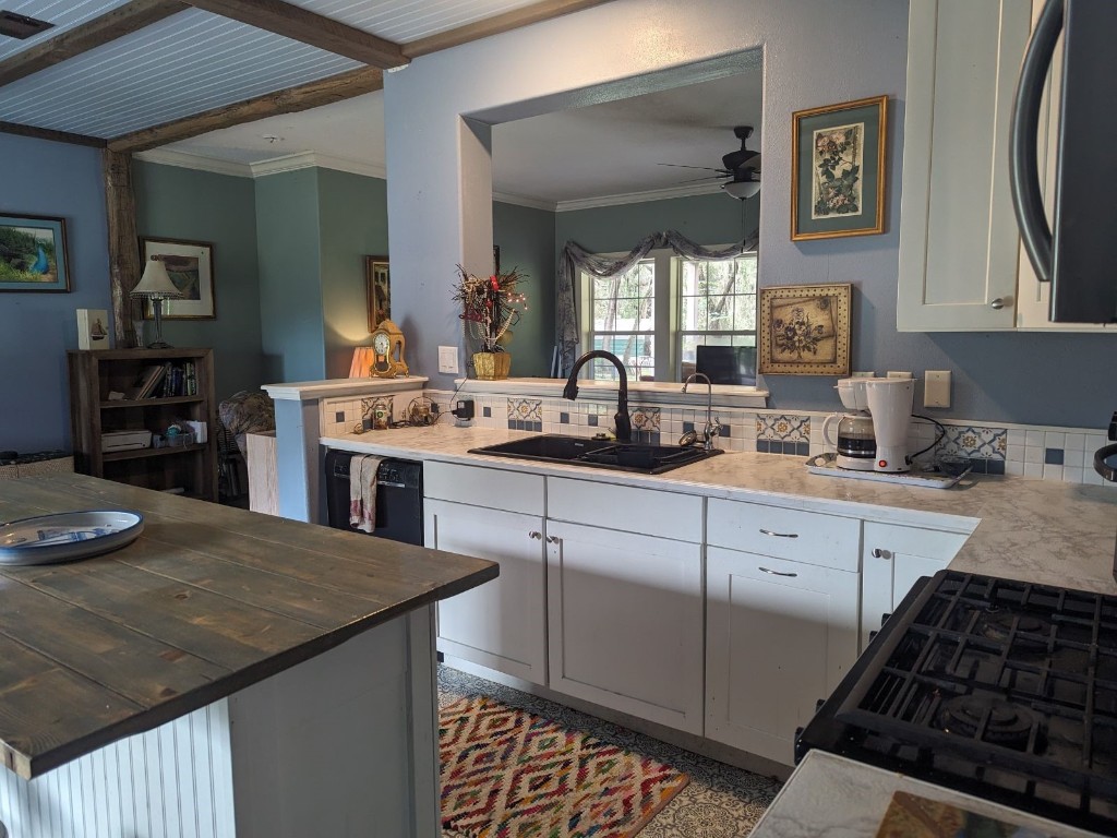 795 Geiger Road Amelia Island, FL 32034 - Photo 7 of 17 a kitchen with stainless steel appliances granite countertop a sink stove and cabinets