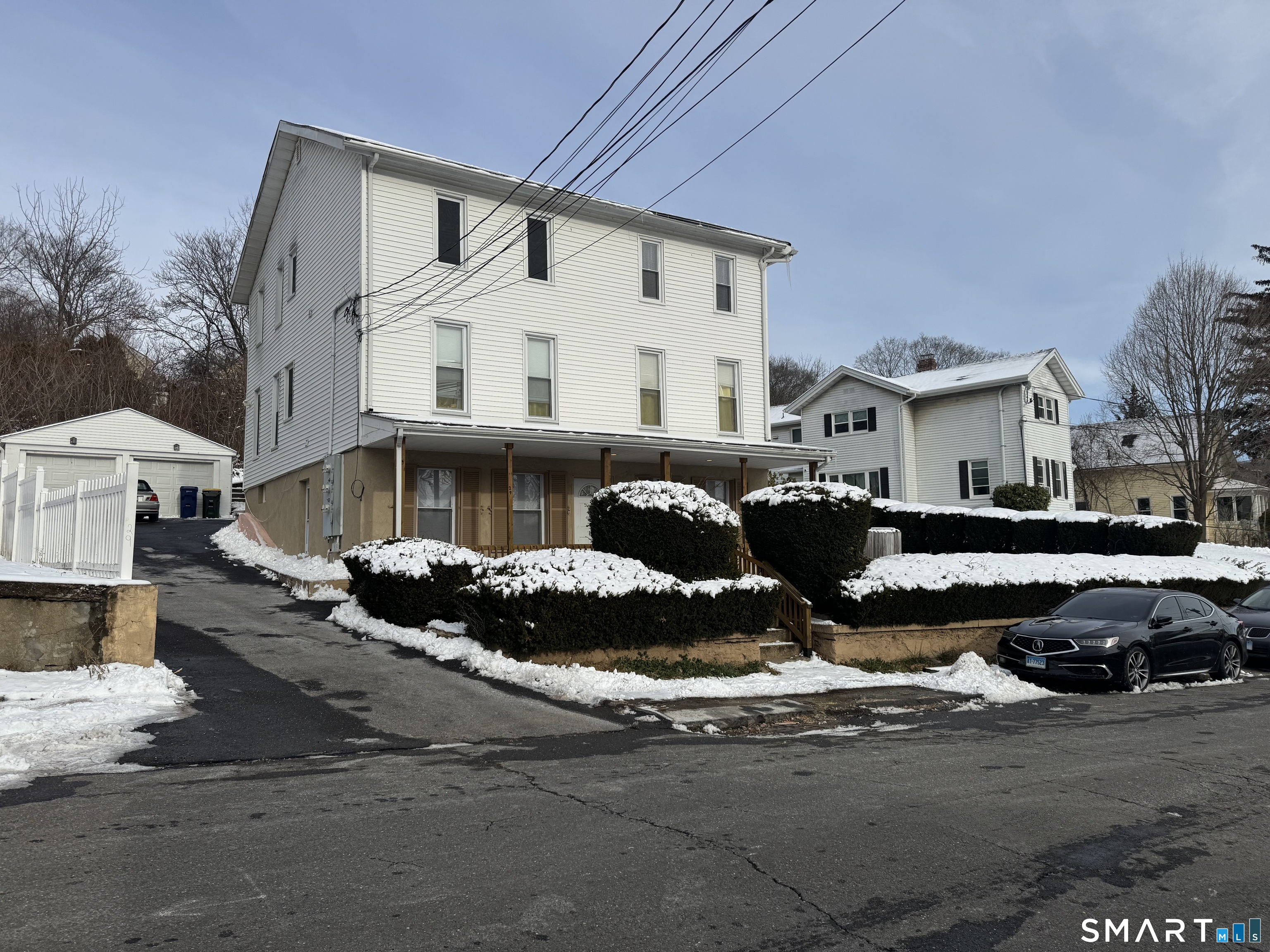 29 Moulthrop Street, Unit 1 Ansonia, CT 06401 - Photo 2 of 11 a front view of a house with barbeque and sitting area