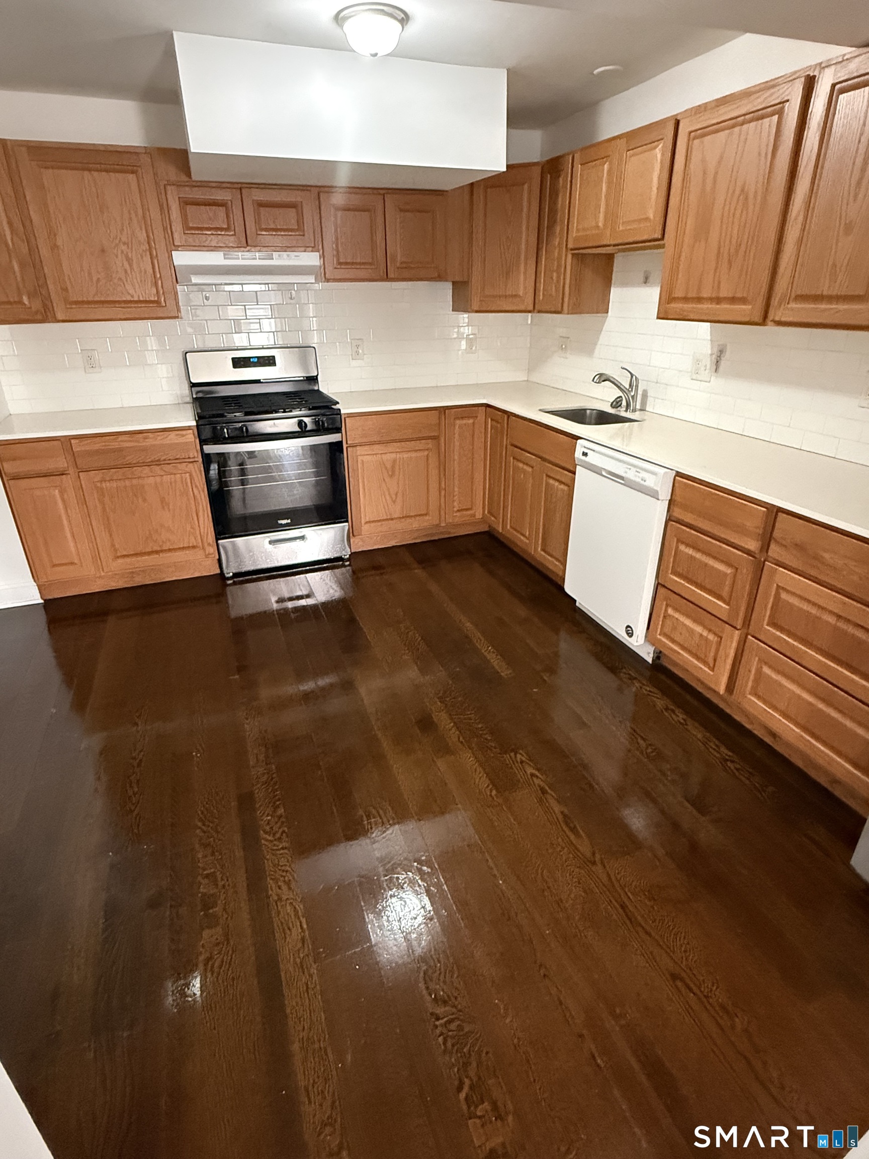 29 Moulthrop Street, Unit 1 Ansonia, CT 06401 - Photo 5 of 11 a kitchen with stainless steel appliances granite countertop a stove a sink and a microwave