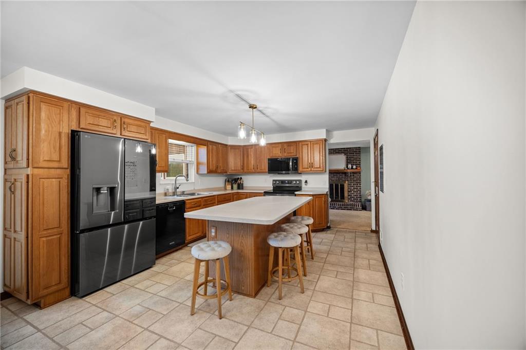 2924 Arrowhead Court Export, PA 15632 - Photo 12 of 37 a kitchen with stainless steel appliances kitchen island granite countertop a refrigerator and a stove top oven