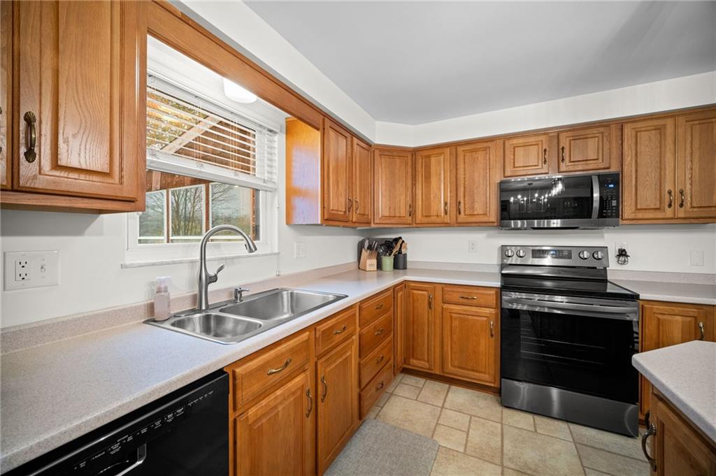 2924 Arrowhead Court Export, PA 15632 - Photo 14 of 37 a kitchen with stainless steel appliances granite countertop a sink and stove top oven