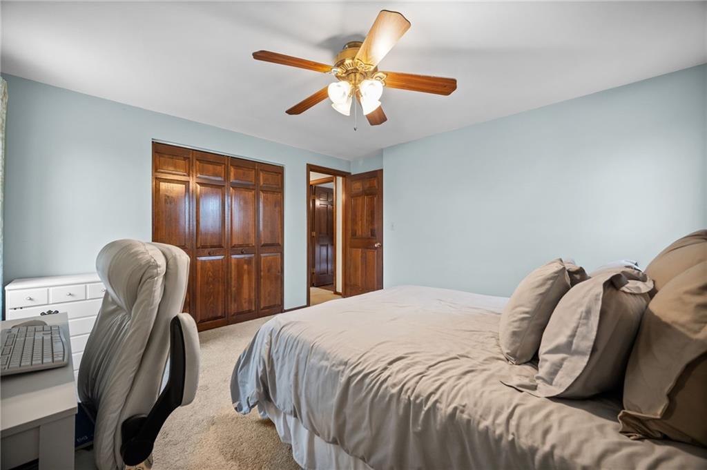 2924 Arrowhead Court Export, PA 15632 - Photo 23 of 37 a bedroom with a bed and a chandelier