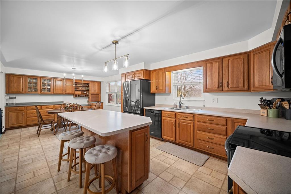 2924 Arrowhead Court Export, PA 15632 - Photo 8 of 37 a kitchen with a table chairs sink and cabinets