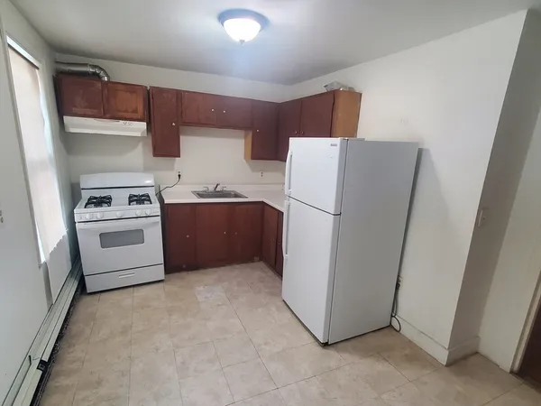 a kitchen with cabinets a sink and white stainless steel appliances