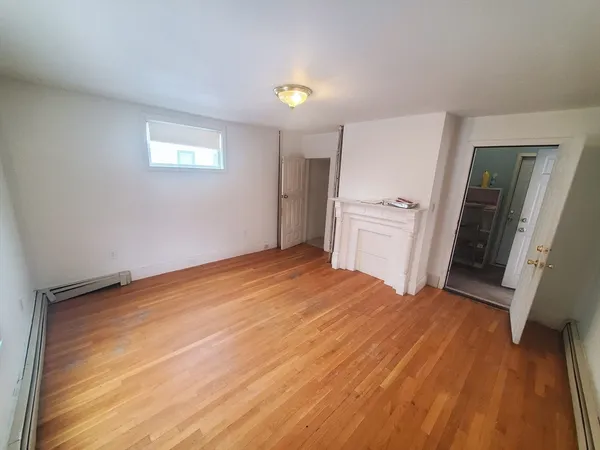 a room with a bed and a dresser