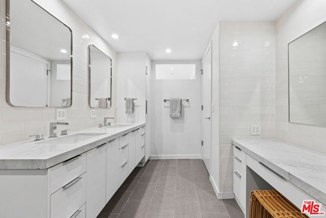 a bathroom with a double vanity sink and mirror
