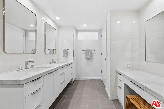 a bathroom with a double vanity sink and mirror
