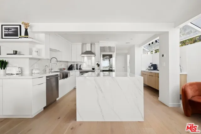 a living room with furniture and kitchen view