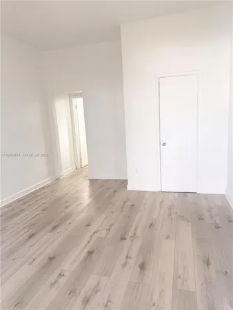 an empty room with wooden floor