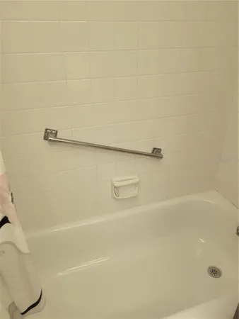 a white toilet sitting next to a shower curtain