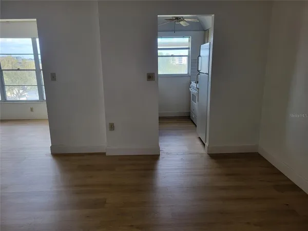 a view of a room with wooden floor and a window