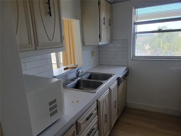 a kitchen that has a sink and a window