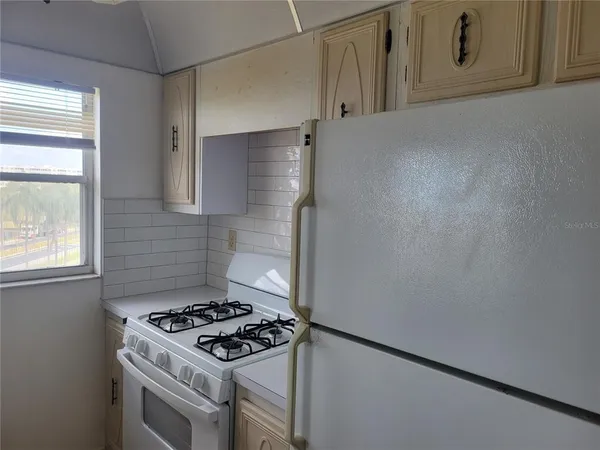 a stove top oven sitting inside of a kitchen