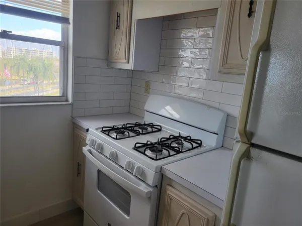 a white stove top oven sitting inside of a kitchen