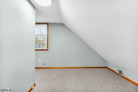 a view of an empty room and a window