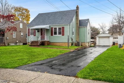 a front view of a house with a yard and table