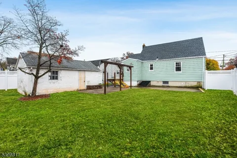 a backyard of a house with table and chairs