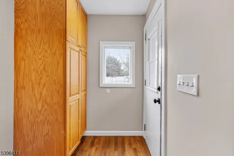 a view of front door with wooden floor