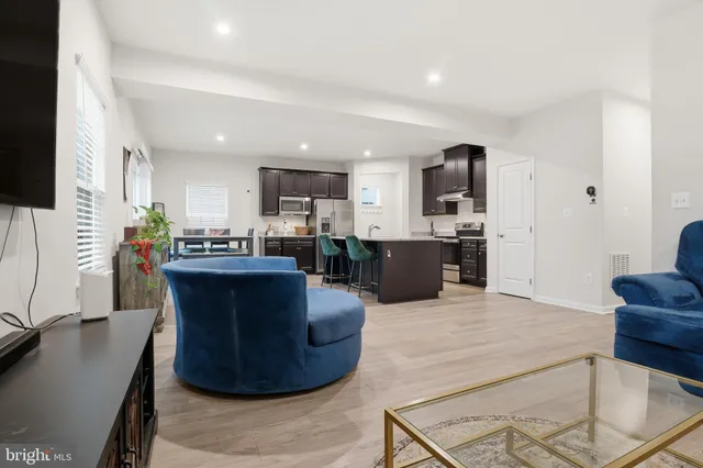 a dining room with furniture and wooden floor