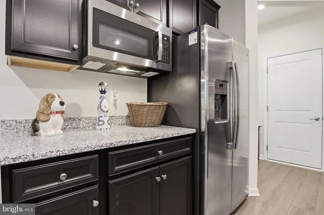a kitchen with stainless steel appliances granite countertop a stove and a microwave