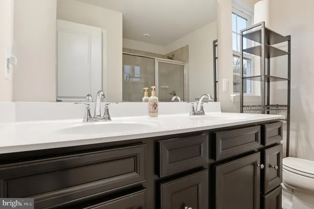 a living room with furniture and a air conditioner vent