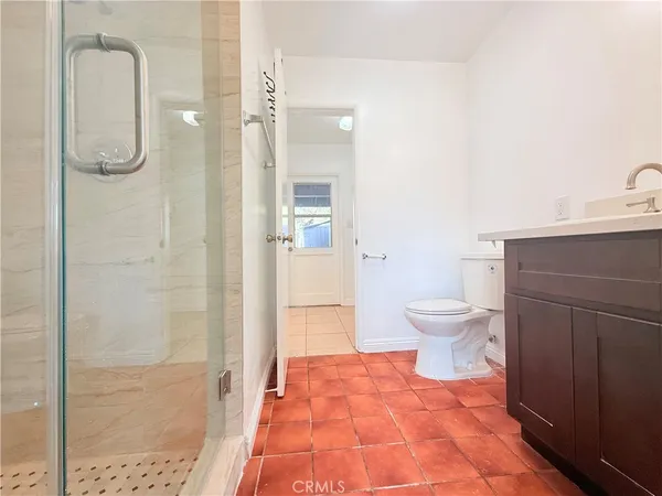 a bathroom with a toilet and a shower